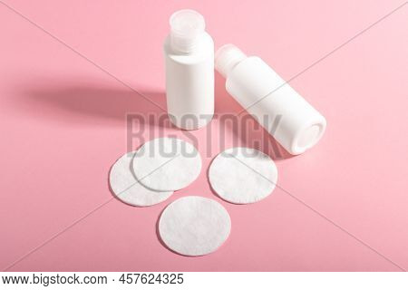 Cotton Pads For Makeup Remover And Cleanser And Cleanser On A Pink Background. The Concept Of Ecolog