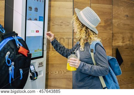 One Adult Woman Choosing, Her Food In A Restaurant Or Bar With A Touch Screen Distributor In Some Fa