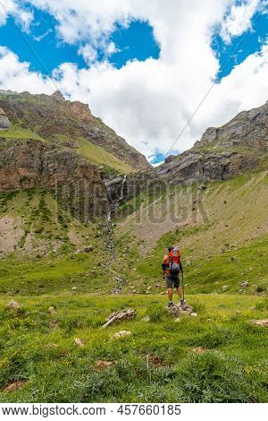 A Young Man Next To The Salto De Tendenera Waterfall In The Ripera Valley, Panticosa, Pyrenees