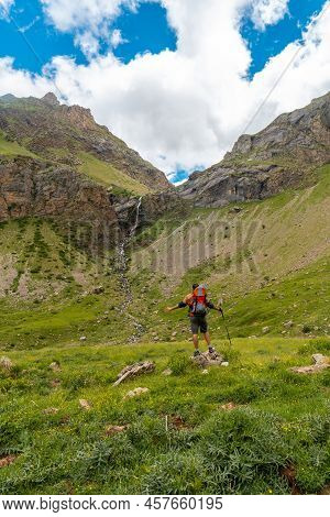 A Young Man Next To The Salto De Tendenera Waterfall In The Ripera Valley, Panticosa, Pyrenees