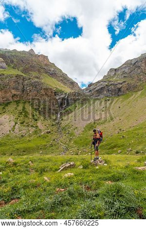 A Young Man Next To The Salto De Tendenera Waterfall In The Ripera Valley, Panticosa, Pyrenees
