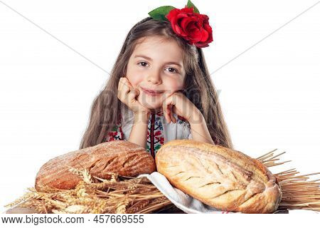 Beautiful Girl And Fresh Homemade Baked Bread. Woman In Traditional Folklore Bulgarian Costume Enjoy