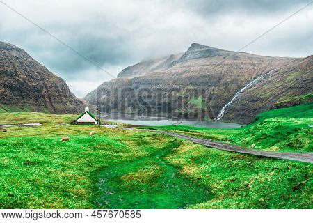 Beautiful Little Church, With A Grassy Roof, Against The Backdrop Of Beautiful Mountains, And Dramat