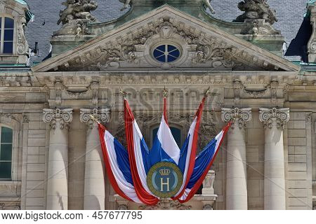 National Day Decorations On Historic Building In Luxembourg - Flags With Monogram H And Crown For Gr