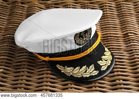 Peaked Cap With Accessories On Wicker Surface, Closeup