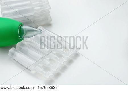 Single Dose Ampoules Of Sterile Isotonic Sea Water Solution And Nasal Aspirator On White Background,