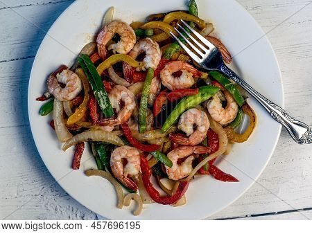 Sauteed Shrimp Served With Sauteed Onons And Peppers,