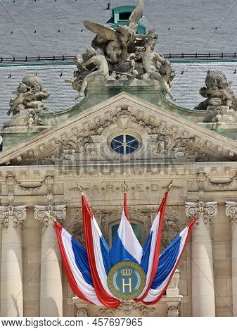 National Day Decorations On Historic Building In Luxembourg - Flags With Monogram H And Crown For Gr
