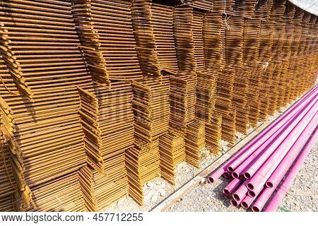 A Heap Of Wiremesh Steel Covering By Rust And Pink Color Plastic Pipe On The Cocrete Floor In Front 