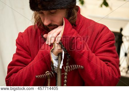 Portrait Of A Male Gunner In A Vintage Swedish Military Uniform With A Ramrod In His Hands. Reconstr