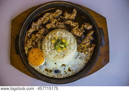 Breakfast With Rice, Fried Egg And Meat Or Beef With Garnish Corn And Leek Close Up Hot Plate Isolat