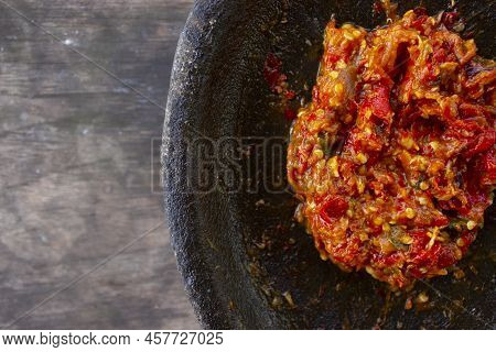 Fresh Sambal Served On Stone Mortar (cobek). Sambal Is Traditional Sauce From Indonesia Made From Ch