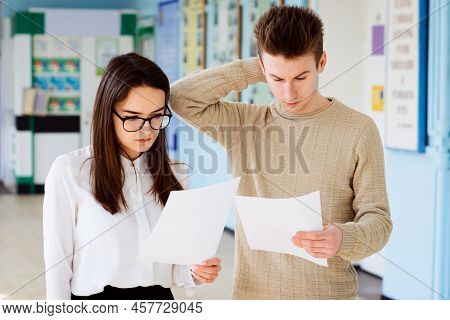 Education, School And People Concept. Two Surprised And Bewildered Students Are Shocked To Get Low G