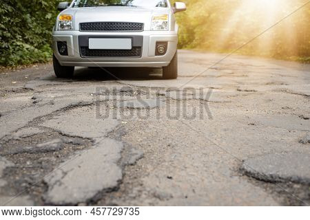 Photo Of Car Driving On Highway With A Lot Of Huge Deep Potholes Those Can Damage Car Vehicle