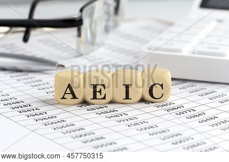 Wooden Cubes With The Word Aeic - Advance Earned Income Credit On A Financial Background With Chart,