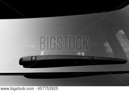 Close Up Of Back Wiper On Black New Car Windows. A Windscreen Wiper Or Windshield Wiper Is A Device 