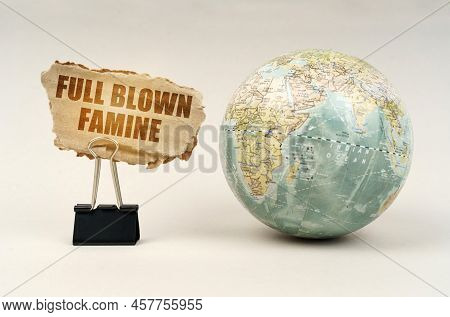 People Concept. Near The Globe There Is A Clip With A Cardboard Plate On Which It Is Written - Full 