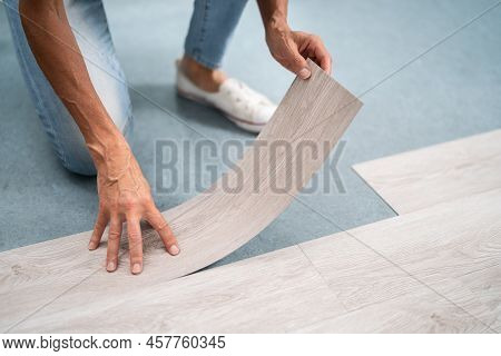 Installing New Vinyl Laminate. Woman Fixing Floor. Diy Project