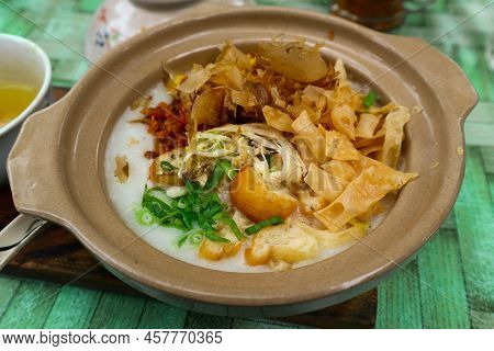 Porridge Served On Hot Claypot Topped With Chicken, Sweet Corn, Skipjack Tuna, Tofu, Green Onions, C