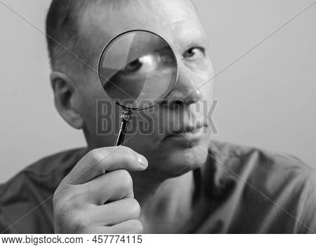Man Looking Through Magnifying Lens Glass Portrait, Investigating, Inspecting You.
