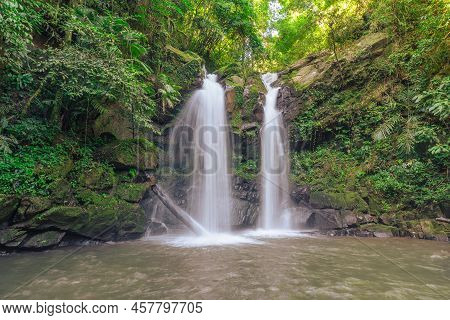 Beautiful Waterfall Scenic Flow From The Top Into The Bottom In The Green Forest.