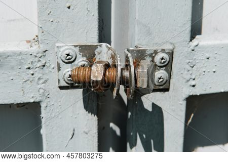 Old Rusty Bolt With Screw Nut Used Like A Lock On The Metal Gate. Homemade Lock.