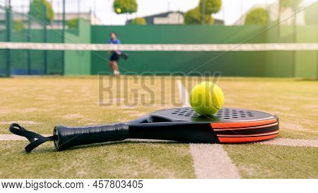 One Caucasian Mature Man Playing Behind Net With Padel Racket And Yellow Ball
