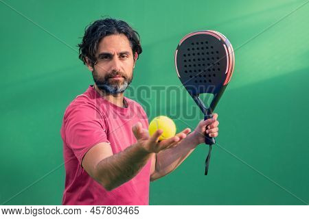 Monitor Of Padel Holding Black Racket With Yellow Tennis Ball In The Hand.