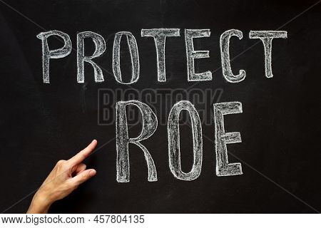 A Womans Hand Points To The Abortion Inscription And The Law Against Abortion.