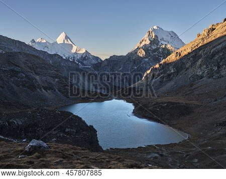 Mount Jampayang, Mount Chanadorje And Lake Boyongcuo At Sunrise In Yading National Park, Daocheng Co