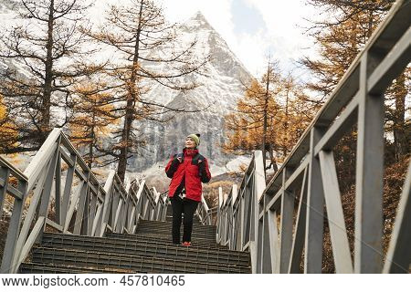 Asian Woman Female Tourist Walking On Steps At The Foot Of Mount Chenrezig In Yading National Park I