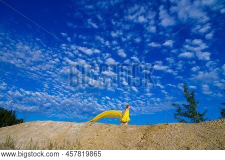 Ukrainian Patriot Girl In A Yellow Dress Against A Blue Sky. Summer Photo. Blue Sky. Sunny Day. Free