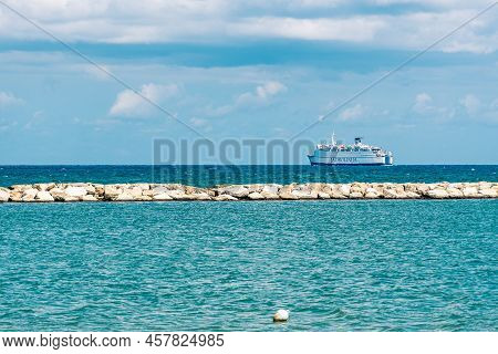 Bari, Puglia, Italy - August 29 2021: Cruise Ship With Blue Sky, White Clouds, Blue Sea And Breakwat