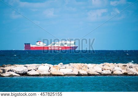 Bari, Puglia, Italy - August 29 2021: Cruise Ship With Blue Sky, White Clouds, Blue Sea And Breakwat