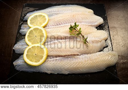 Panga Fillets, Pterogymnus Laniarius White Fish From Asia, Mild Flavor With Lemon Slices And Dark Ba