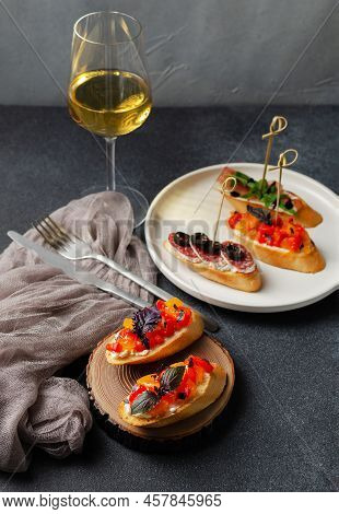 Brushetta, Antipasti  Or Authentic Traditional Spanish Tapas Set With Wine On The Dark Background. V