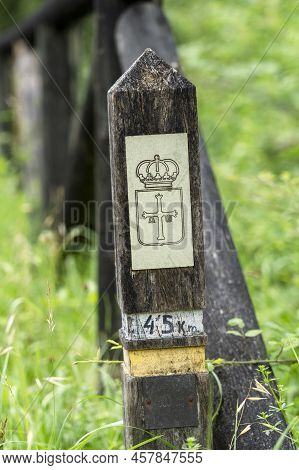 Oviedo, Spain - July 06, 2022: Old Wooden Post With The Coat Of Arms Of Asturias Along With A Hiking