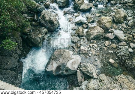 Small Waterfall Tumbling And Splashing Down In Bealey River In Southern Alps