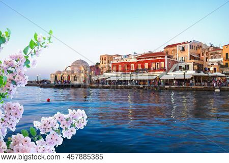 Embankment And Venetian Habour With Turkish Mosque Yiali Tzami Of Chania At Sunset With Flowers, Cre