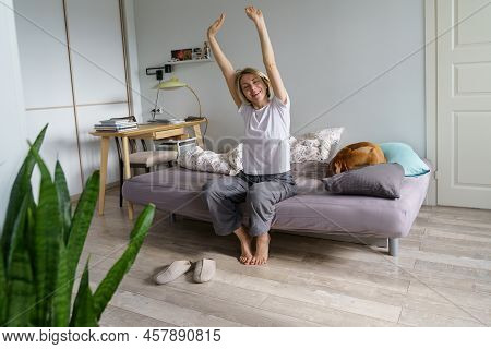 Happy Woman In Nightwear Sitting In Bed Awakened From Enough And Healthy Sleep Feels Good, Stretchin