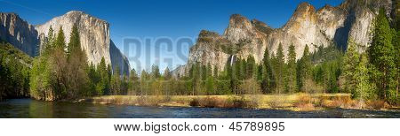Yosemite Valley panorama showing the upper Yosemite Falls and the Bridalveil Falls with the Merced river in the foreground