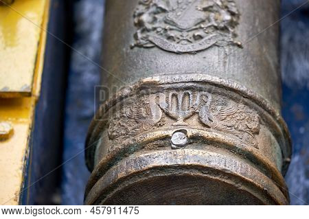 Vintage Swedish Cannons And Metal Cannonballs. Ancient Military Arsenal Of The Events Of The Russian