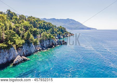 Picturesque Sea Adriatic Coast Of Montenegro. Turquoise Mediteran Sea And Rocky Shore With Evergreen