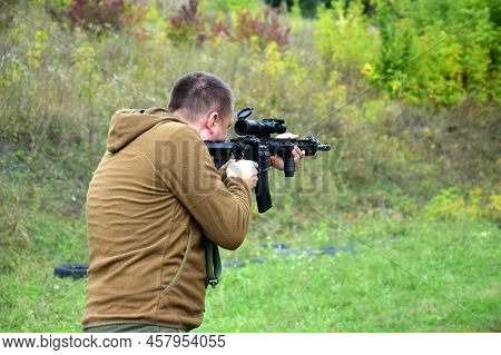 Kharkiv, Ukraine - September 4, 2021: A Young Guy Is Trained In Combat Shooting From A Rifle Ar 15. 