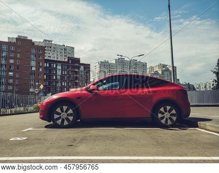 Moscow, Russia - July 2022: Electric Car Tesla Model Y On Street During Daytime, Parked In Front Of 