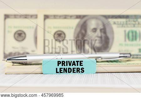 Business Concept. On The Dollars Are A Pen And A Sign With The Inscription - Private Lenders. In The