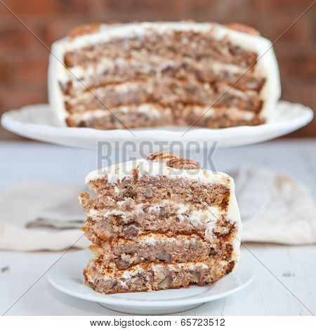 A Piece Of Hummingbird Cake With Pecans And Cream Cheese Frosting
