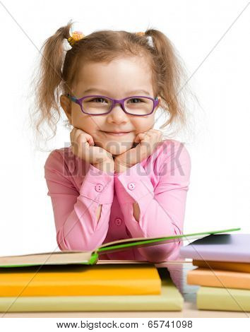 child girl in glasses reading book and smiling