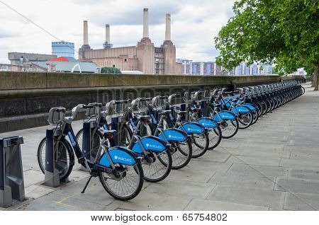 LONDON, UK - CIRCA JULY 2011: Barclays Cycle Hire station opposite Battersea power station. Barclays Cycle Hire is a public bicycle sharing scheme launched on July 30, 2010.