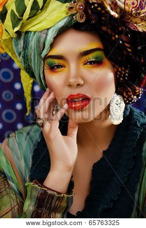 beauty bright woman with creative make up, many shawls on head like cubian woman